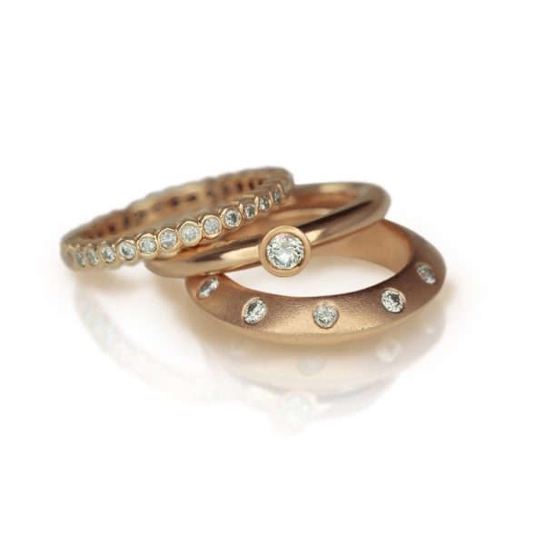 Red Gold Diamond Flute Ring stacked with Red Gold Diamond Eternity Band and Red Gold Knife Edge Diamond Studded Stacking Ring by Scarab Jewellery Studio