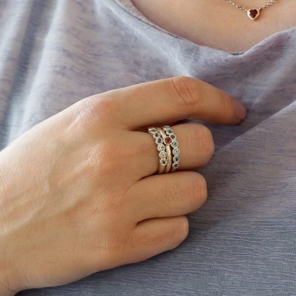 Silver Seven Stone Ring stacked with Silver Flute Ring by Scarab Jewellery Studio