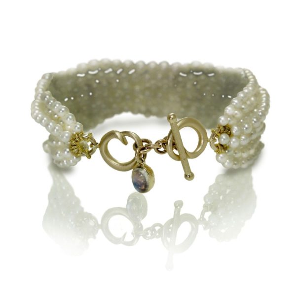 Six Strand White Pearl Bead Bracelet with two rose gold celtic spirals and oval Rainbow Moonstone cabouchon charm